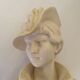 Bust of a young woman in the hat of A. Giannelli