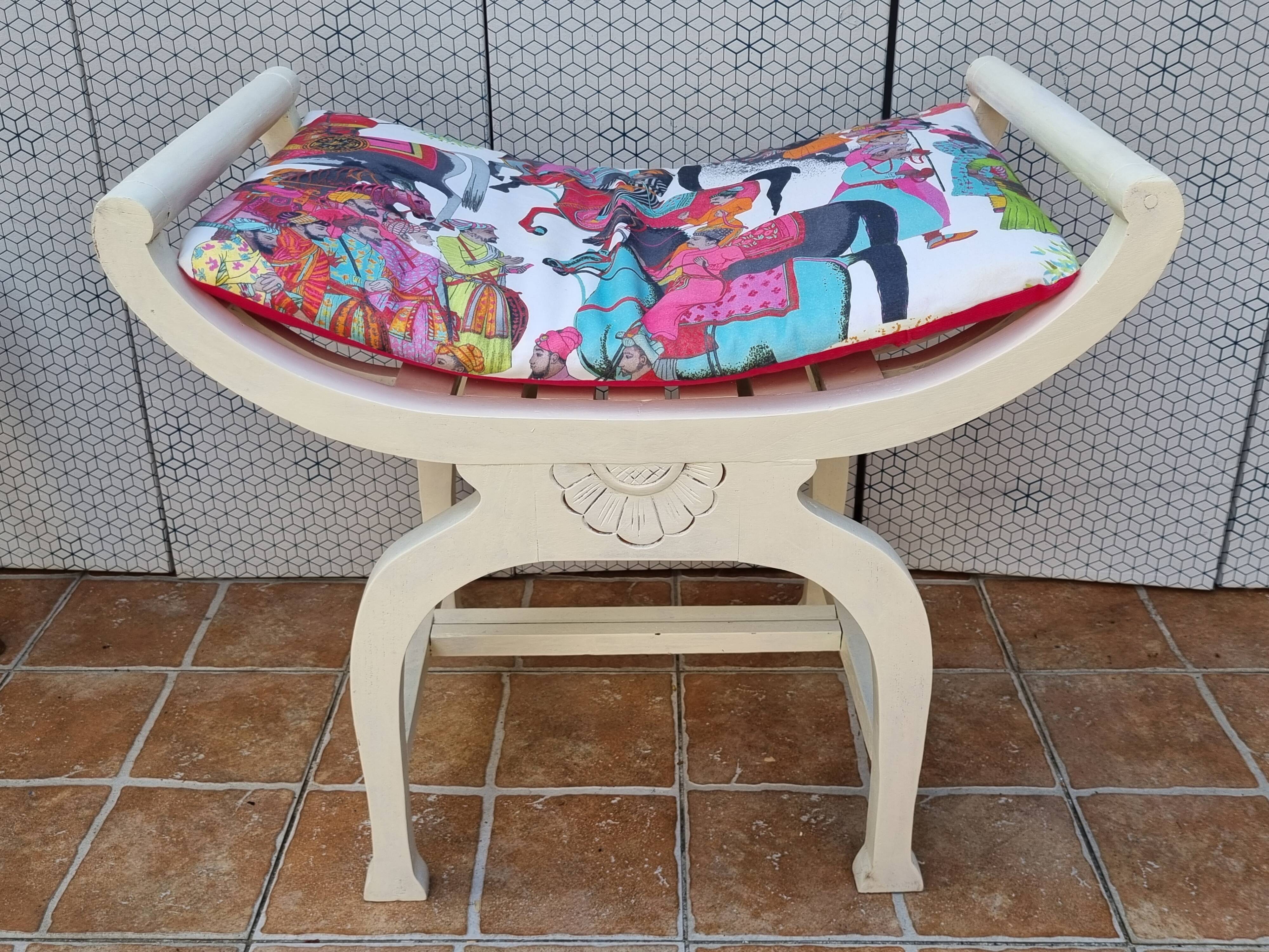 Curule stool in patinated carved wood, Manuel Canovas seat, 60 cm