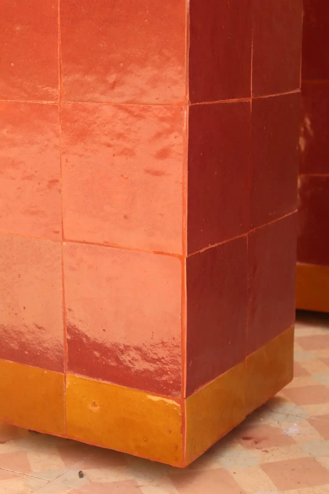 Modern coffee table in burgundy zellige with a tempered glass top.