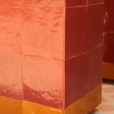 Modern coffee table in burgundy zellige with a tempered glass top.