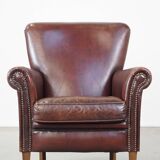 Sheepskin armchair correctly finished with decorative nails and in good condition