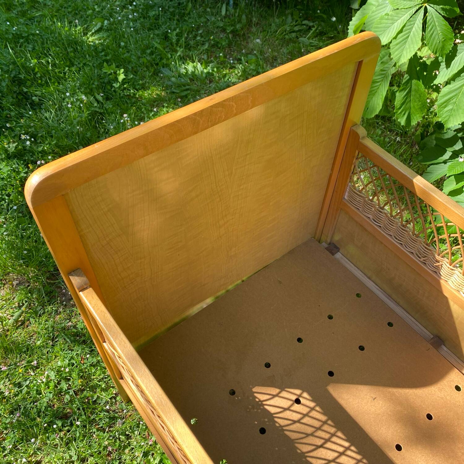 Vintage wooden and rattan baby cot from the 1960s.