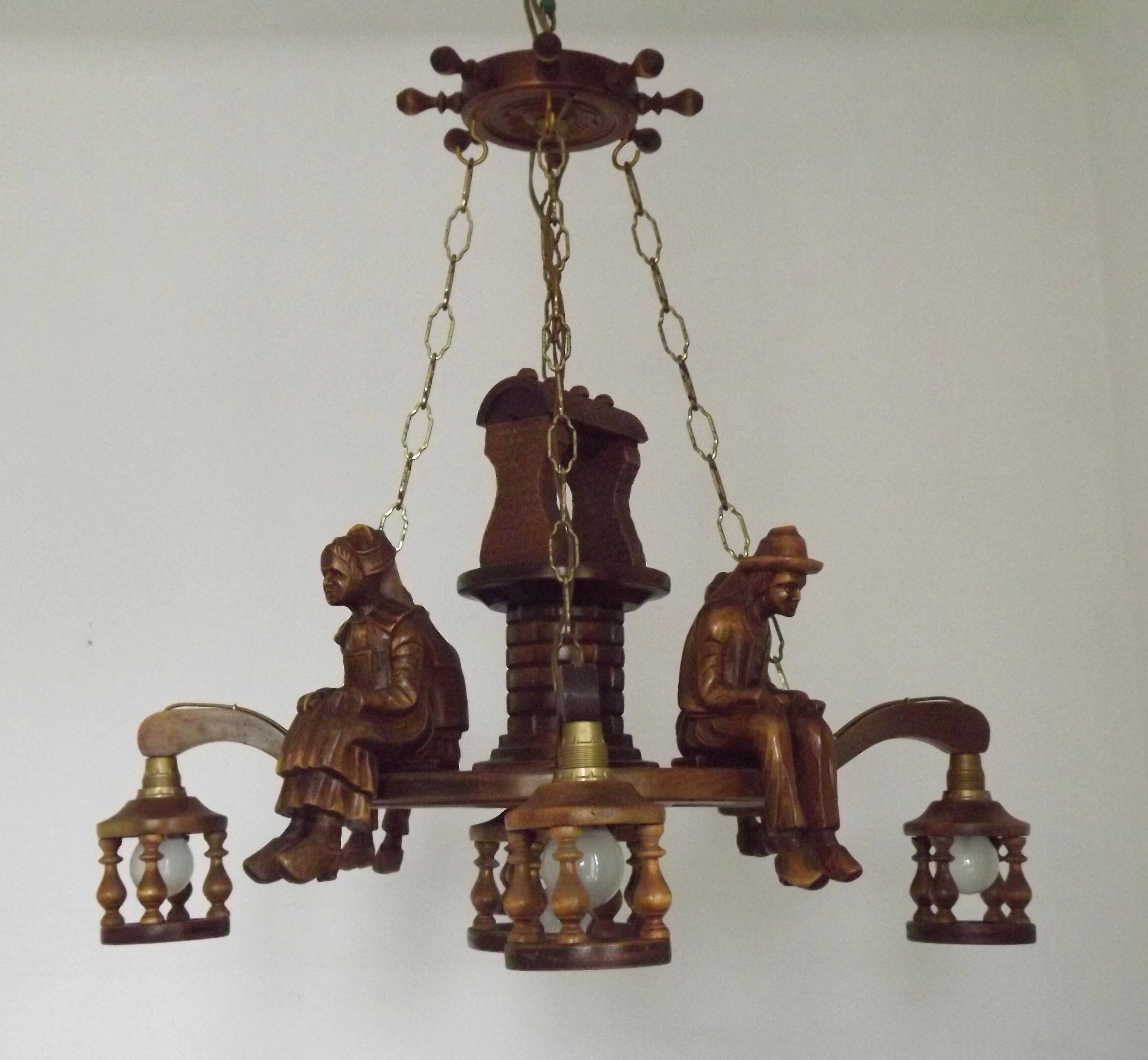 French vintage Breton chandelier with hand-carved figures, well, and lantern lights.