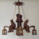 French vintage Breton chandelier with hand-carved figures, well, and lantern lights.