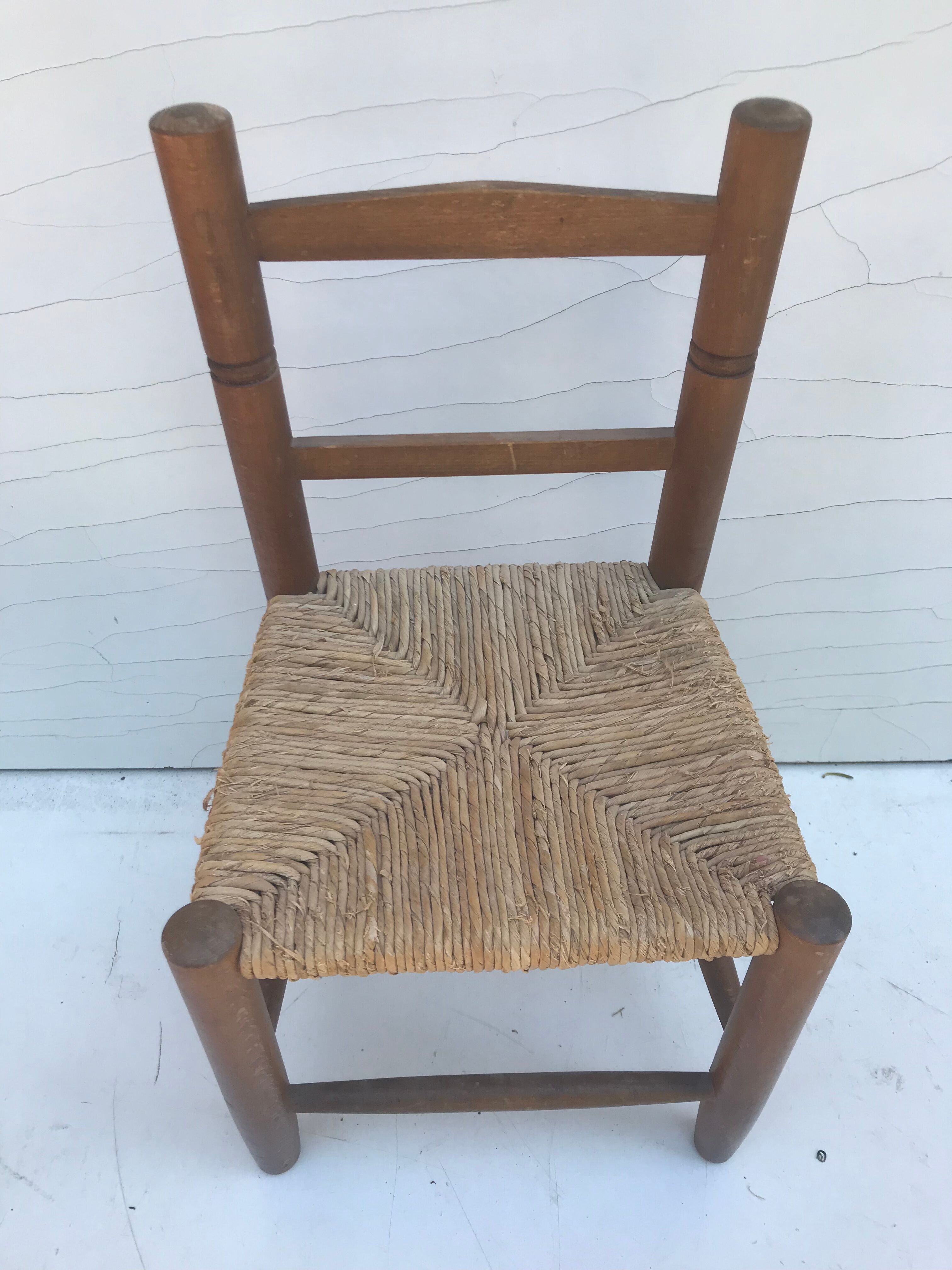 Old wooden children's chair with vintage braided seat