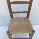 Old wooden children's chair with vintage braided seat