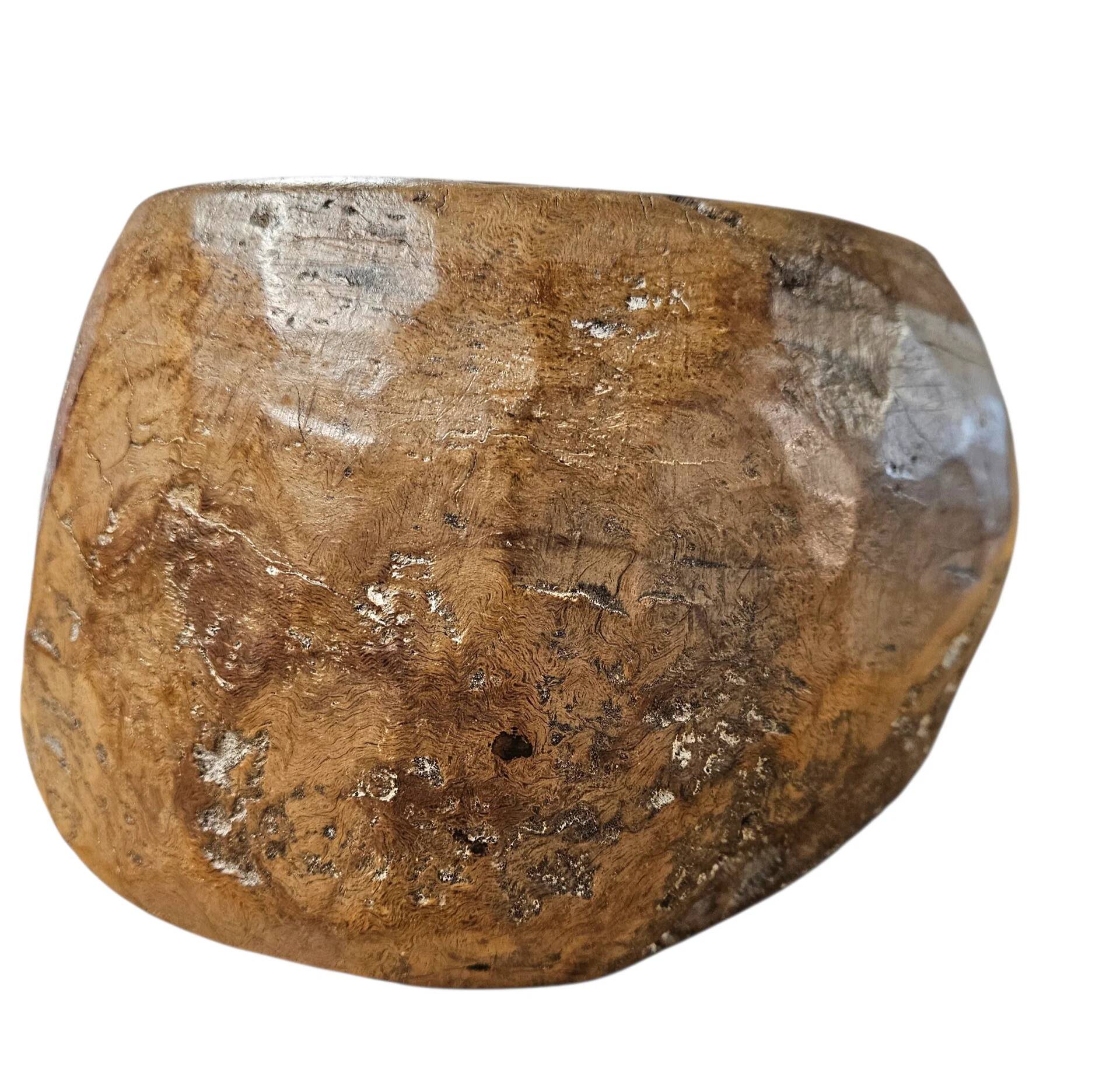 A substantial hand-hewn wooden bowl carved from a single burl section