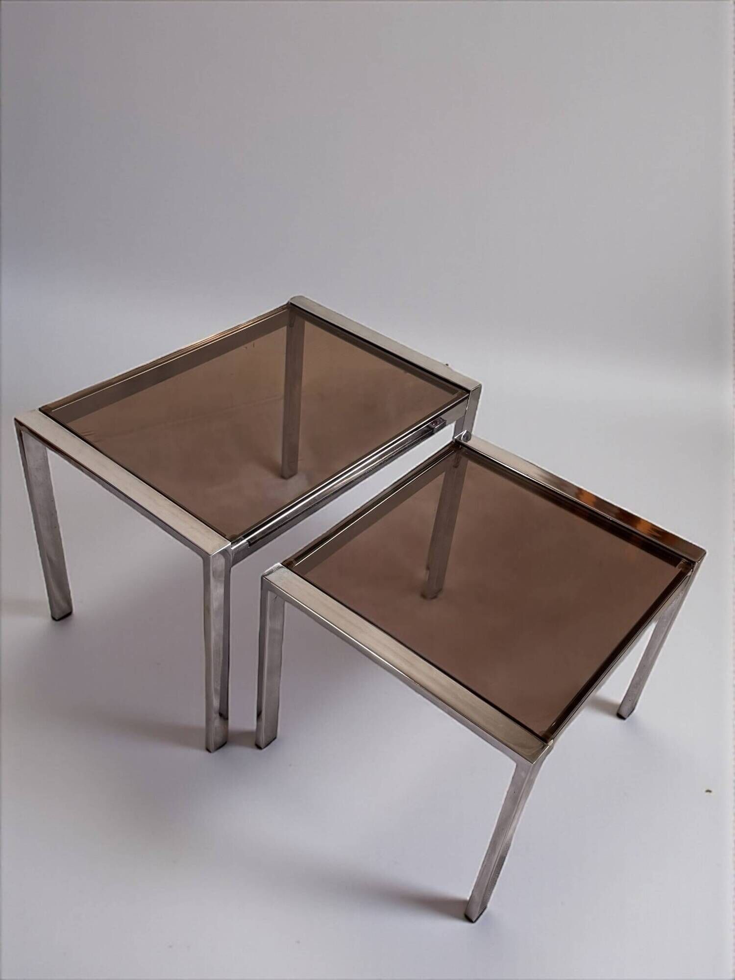 Vintage 1970s nesting tables in chrome and smoked glass, mid-century modernist style