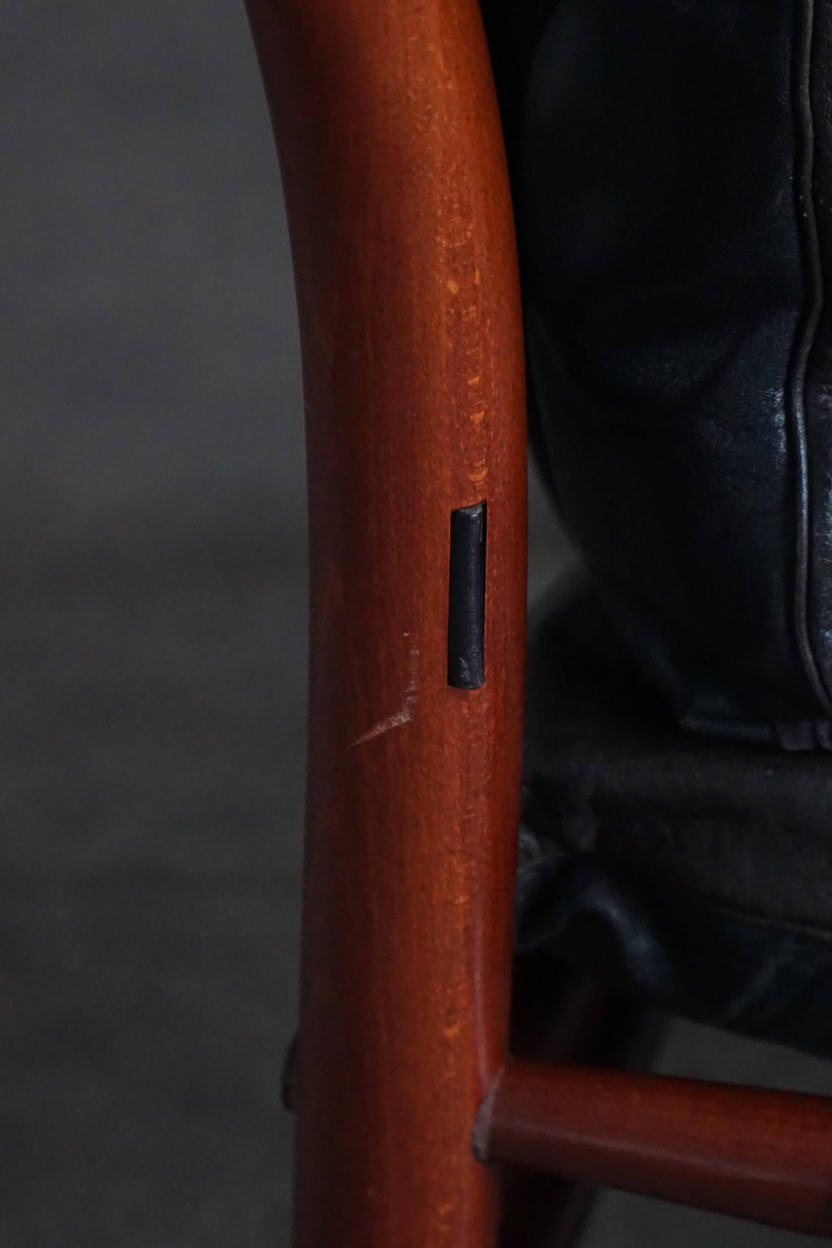 "Lounge chair 'Ilona' by Arne Norell in stained beech and leather, mid-20th century."