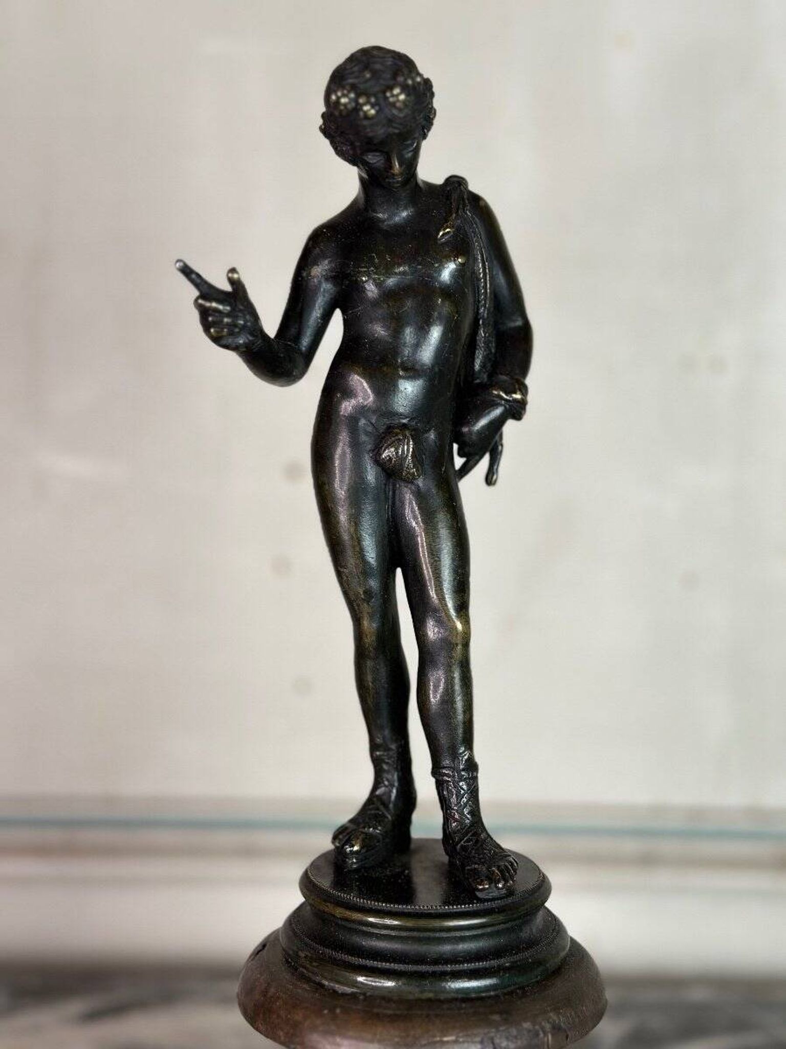Narcissus, bronze after the antique on a wooden base, circa 1880.