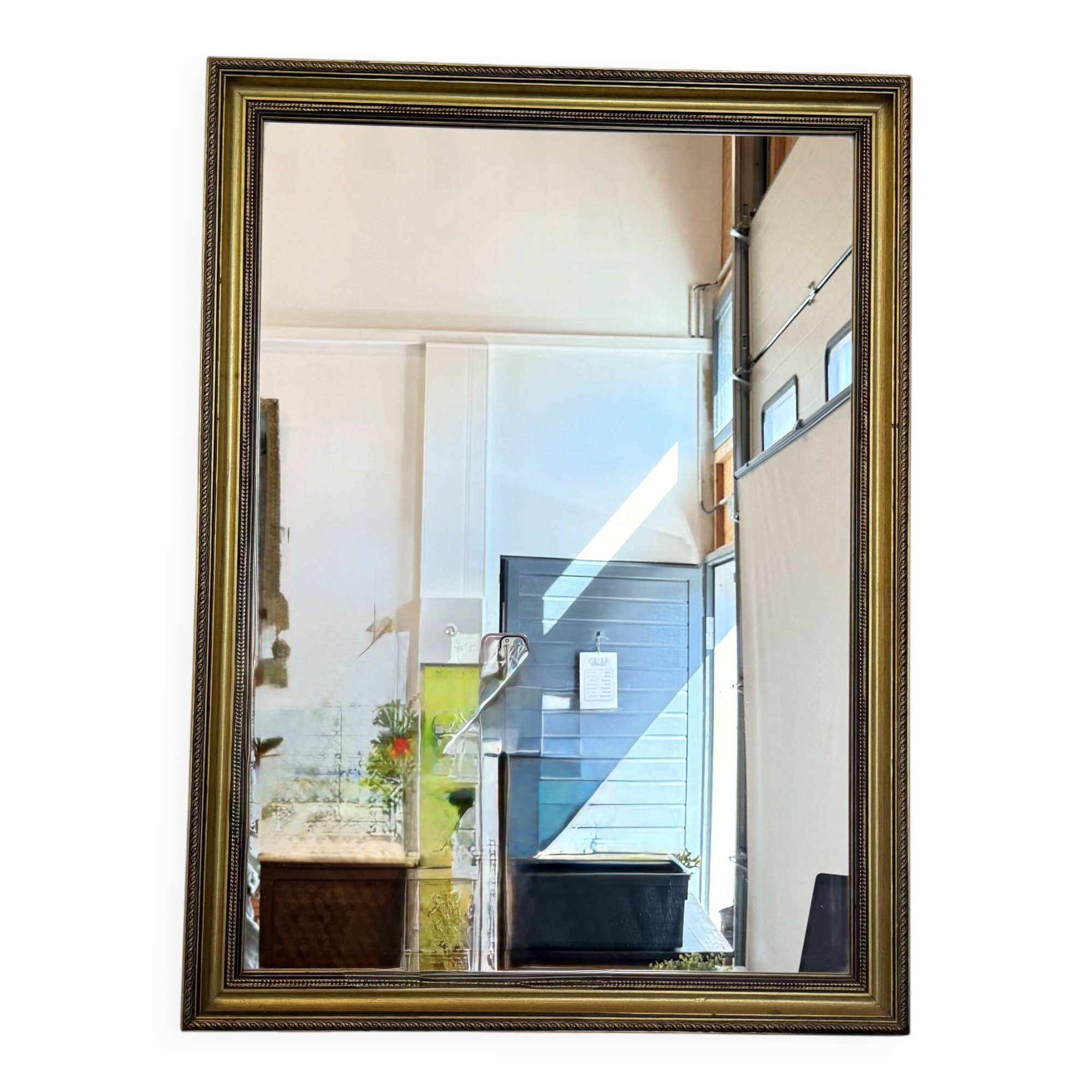 Vintage rectangular wall mirror with a golden wooden frame.