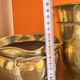 Pair of brass plant pots, decorated with cord and tassels.