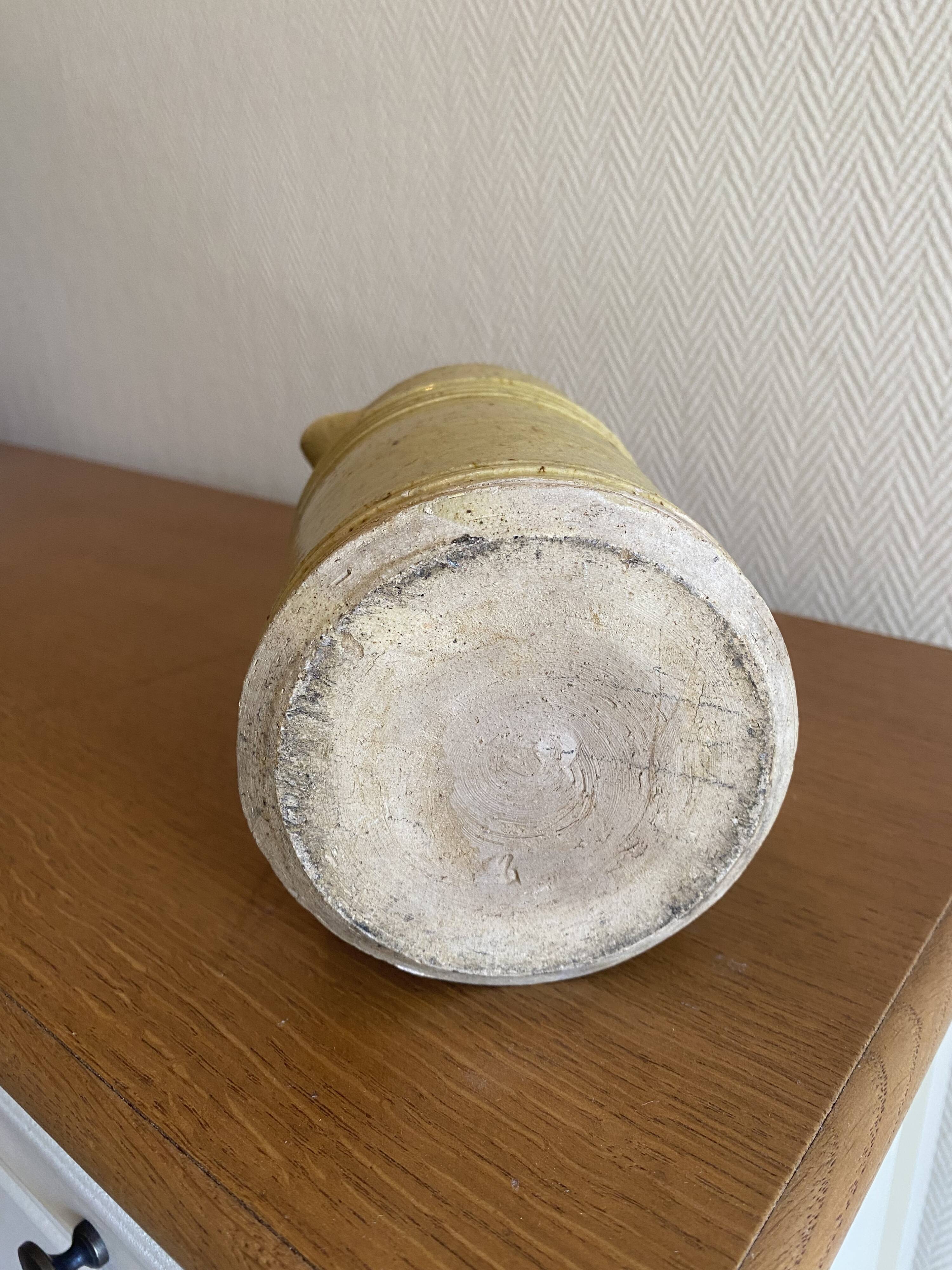 Old yellow glazed terracotta jug from southern France.