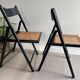 Vintage folding chairs in black wood and cane.