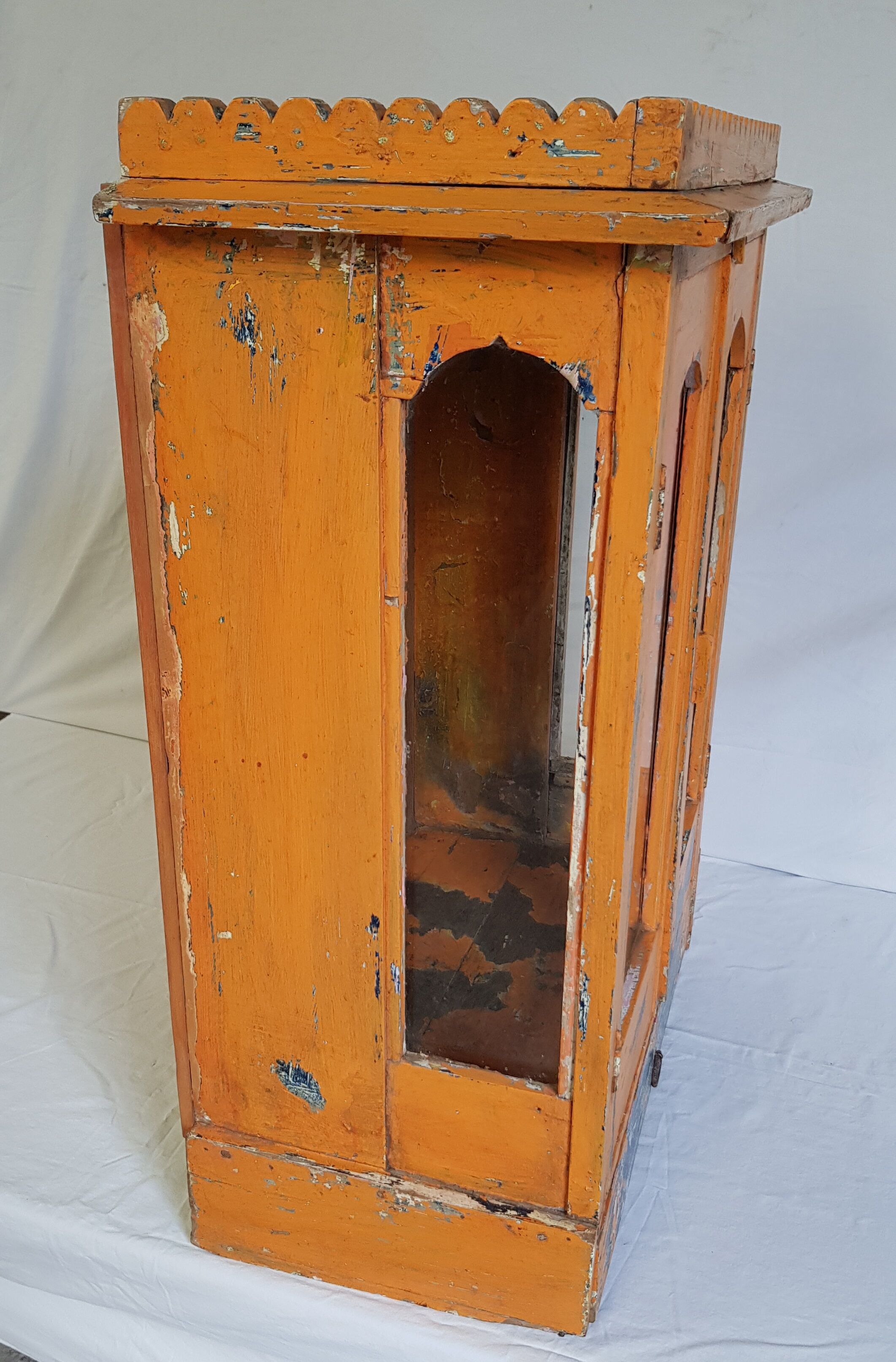 Old temple-showcase with teak offerings