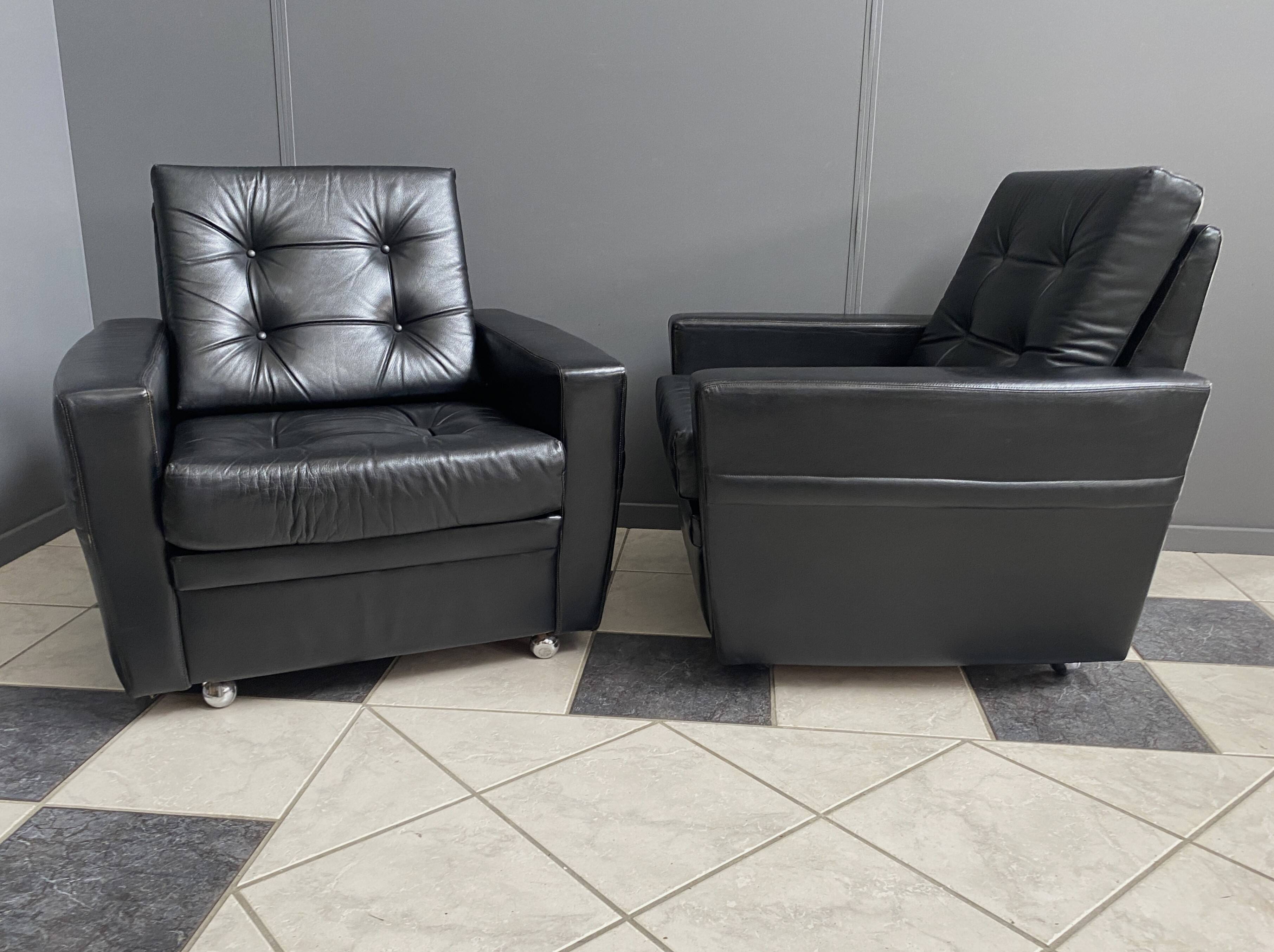 2 Black leather arm chairs 1960s on wheels
