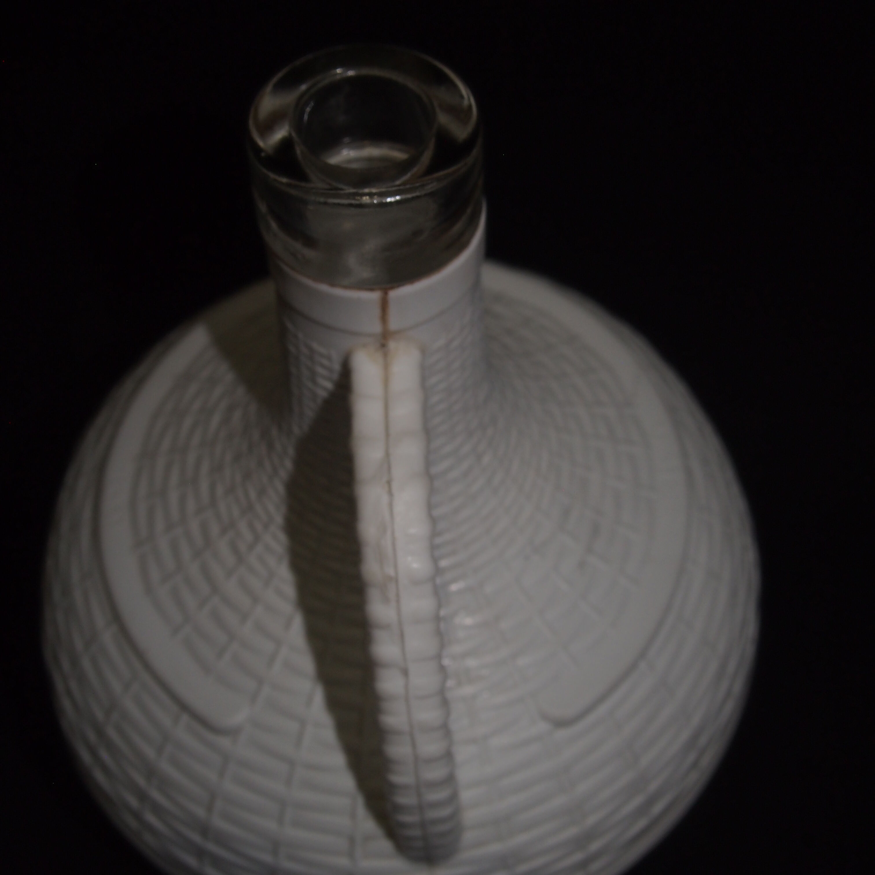 Pair of white covered demijohns