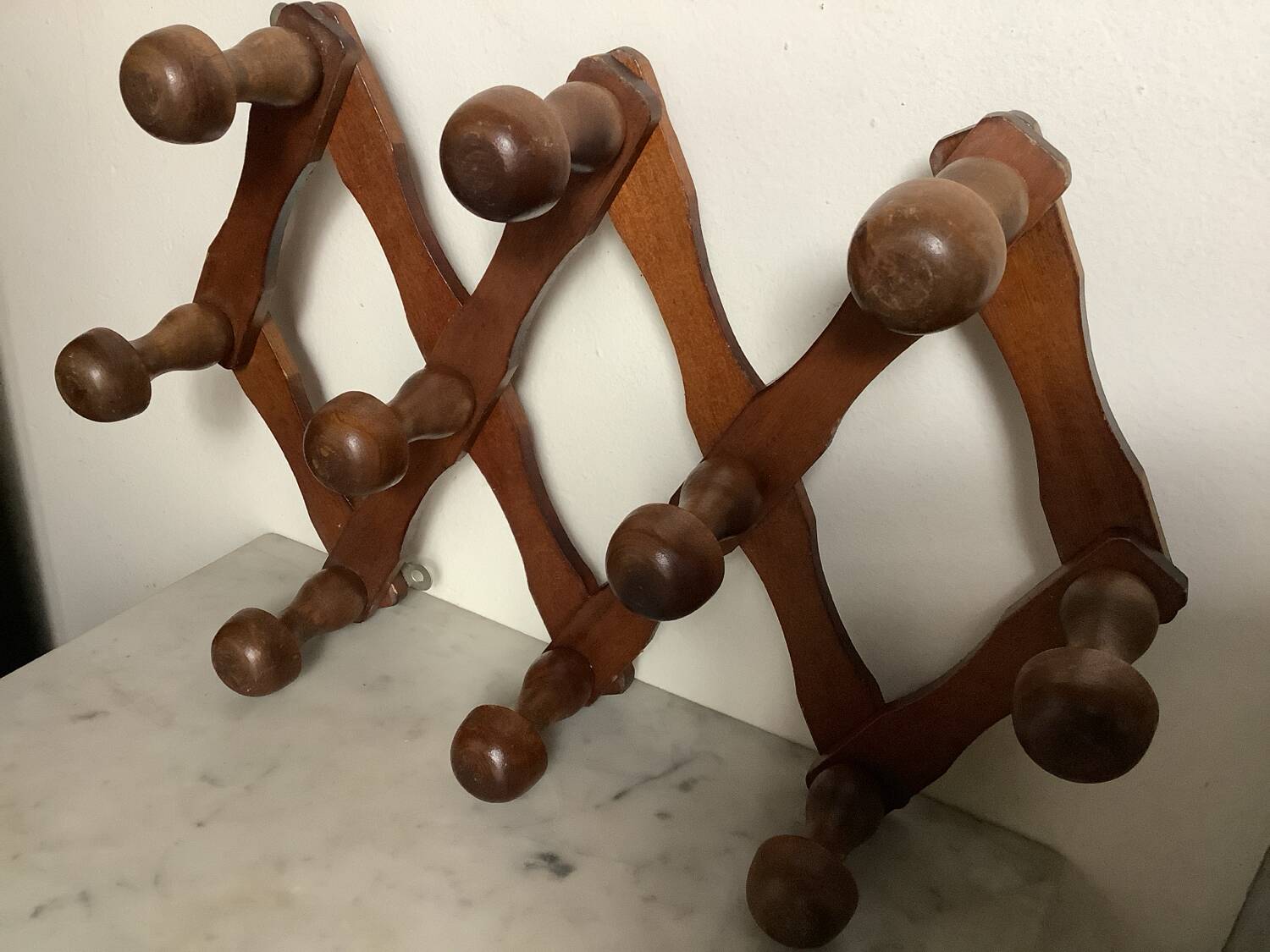 Old wooden accordion coat rack.