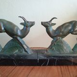 Pair - Chamois metal bookends with green patina & black marble base