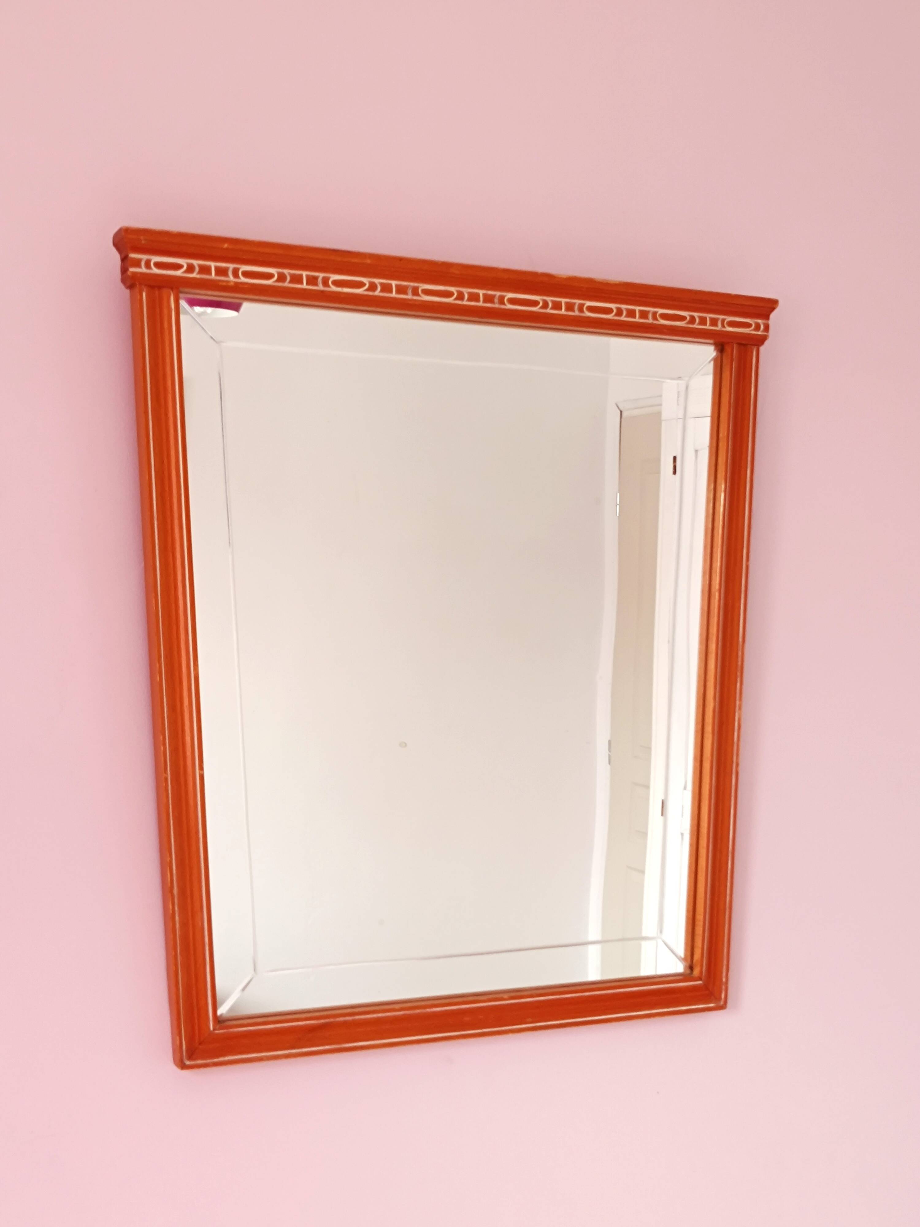 Beveled glass wall mirror in solid wood frame