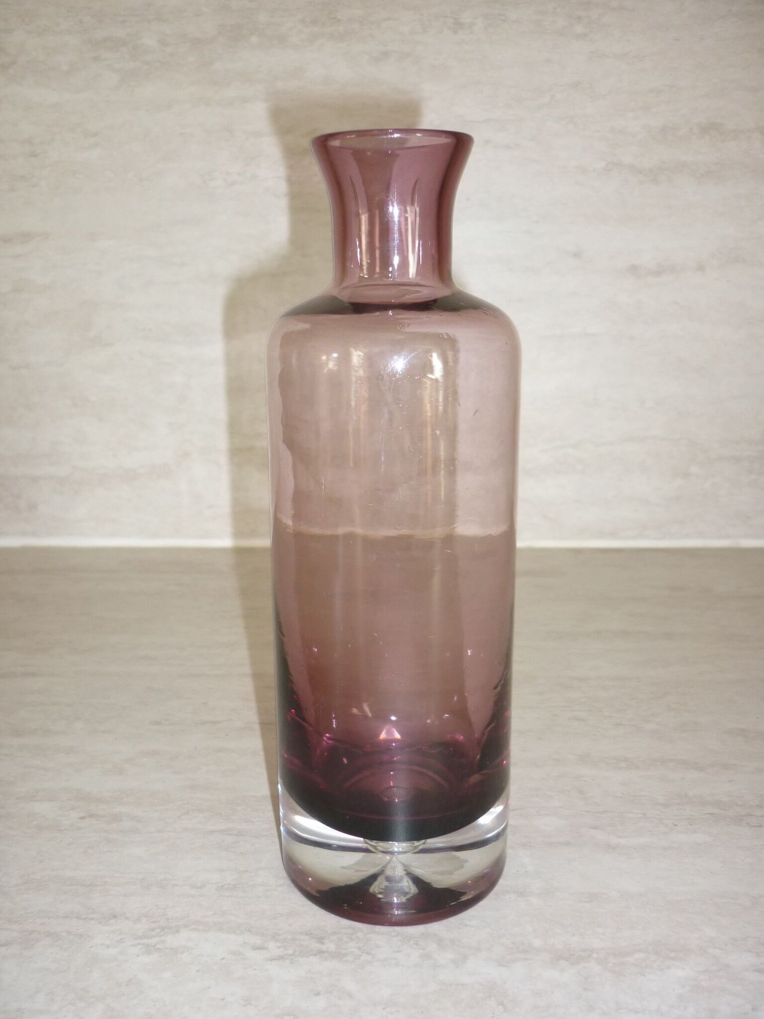 Plum-colored glass bottle with bubble