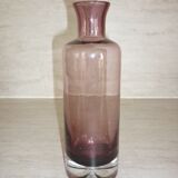 Plum-colored glass bottle with bubble