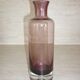Plum-colored glass bottle with bubble