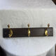 Wooden coat rack with double brass hooks
