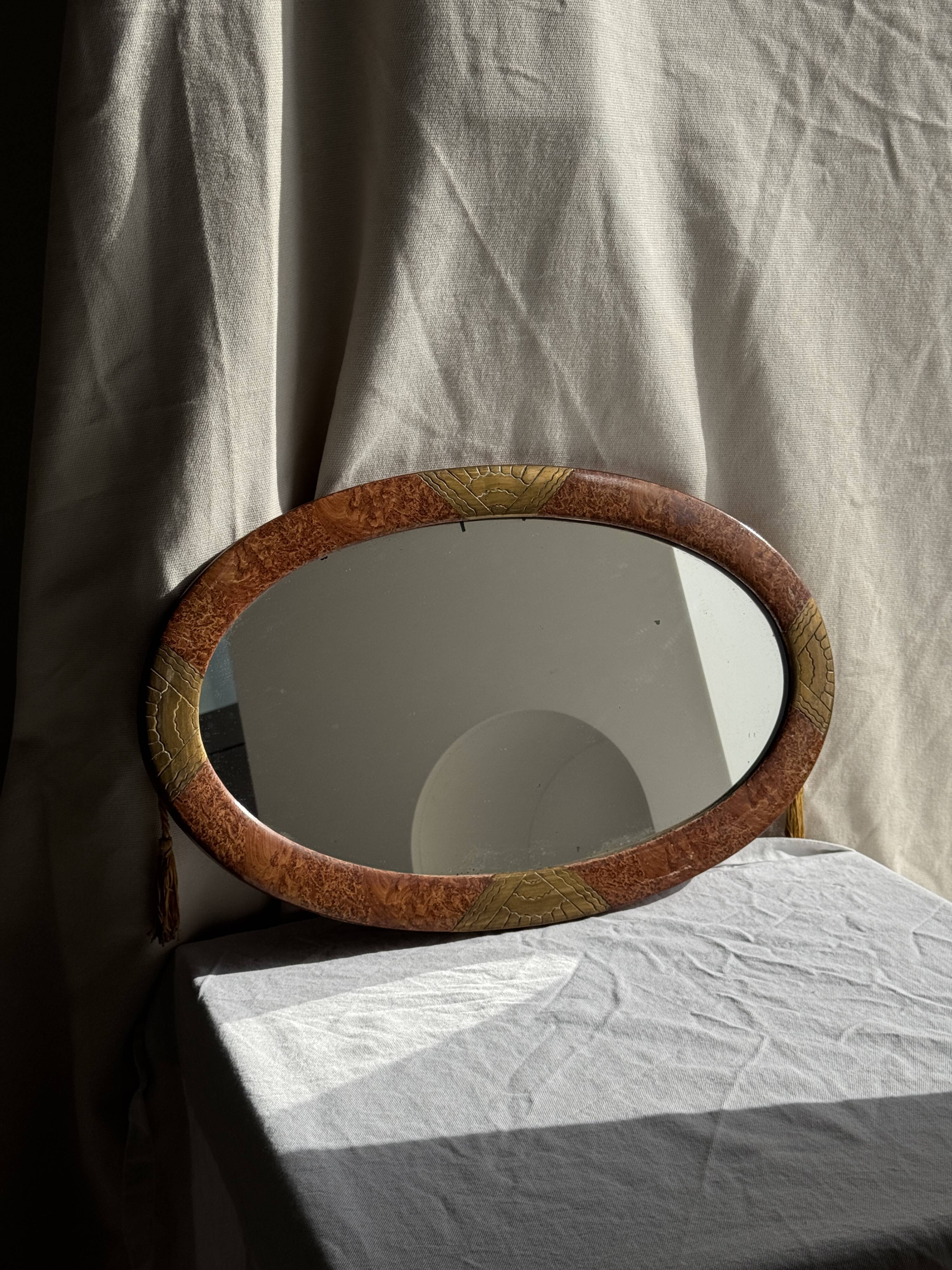 Small oval Art Deco mirror in brown and gold 33x54.