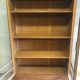 Old school glass bookcase in blond wood