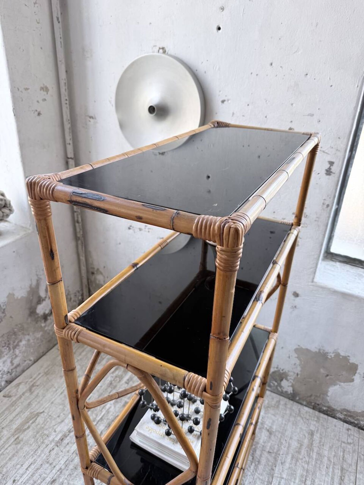 Rattan bookshelf and black glasses