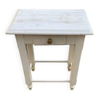 Small white wooden side table, 1920s, with a drawer and turned legs.