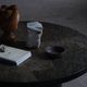 Round brutalist coffee table in stone and steel, mid-century French modernism, 1970s.