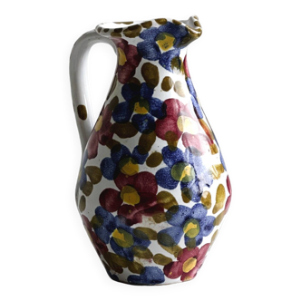 White ceramic milk jug decorated with colorful floral patterns