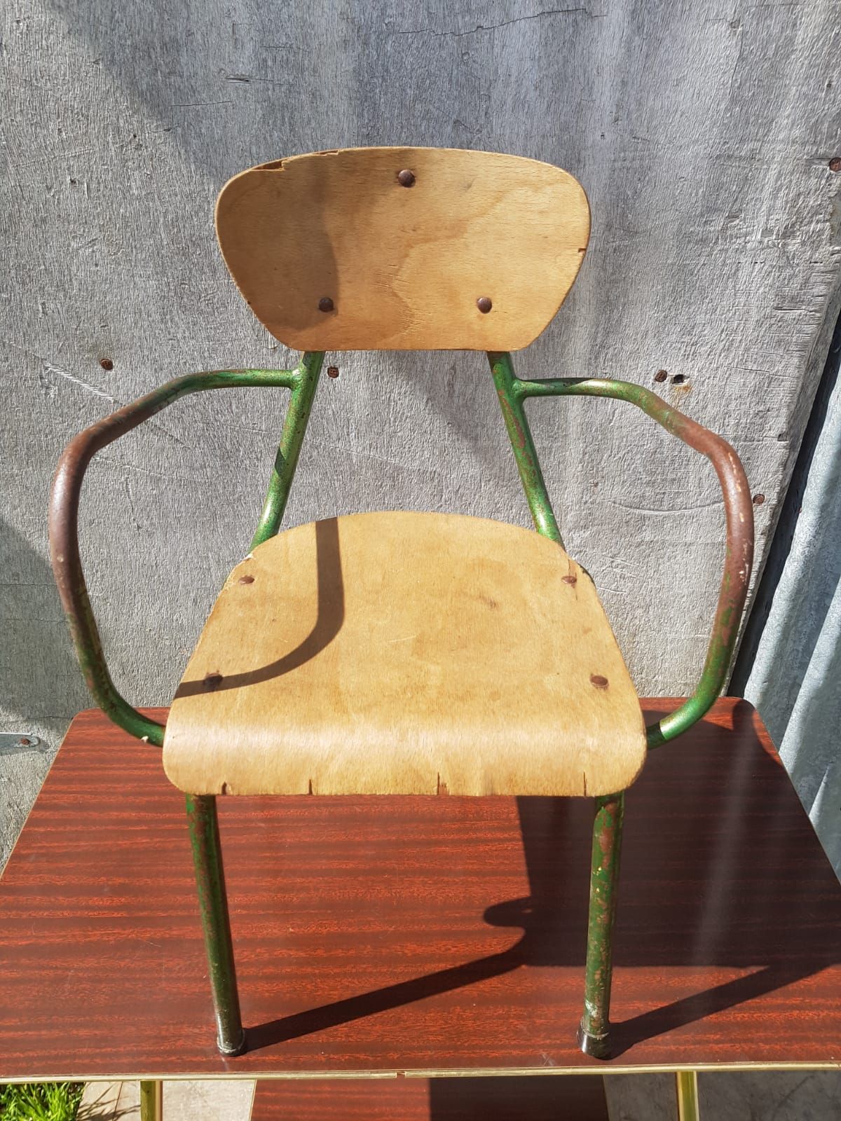 Former green metal child chair