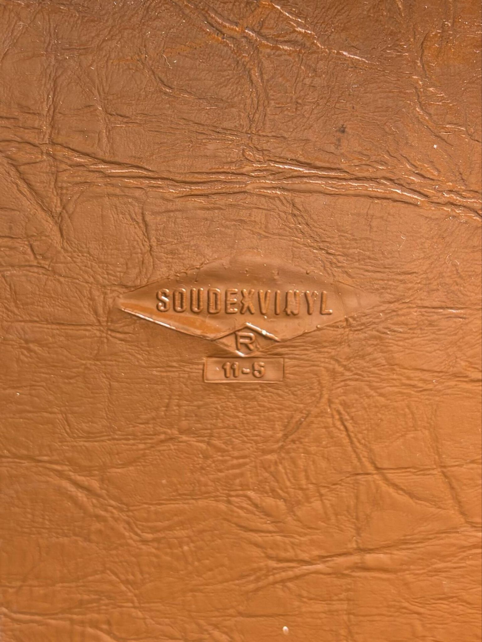 Brown folding chair in vinyl and steel