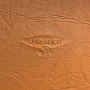 Brown folding chair in vinyl and steel
