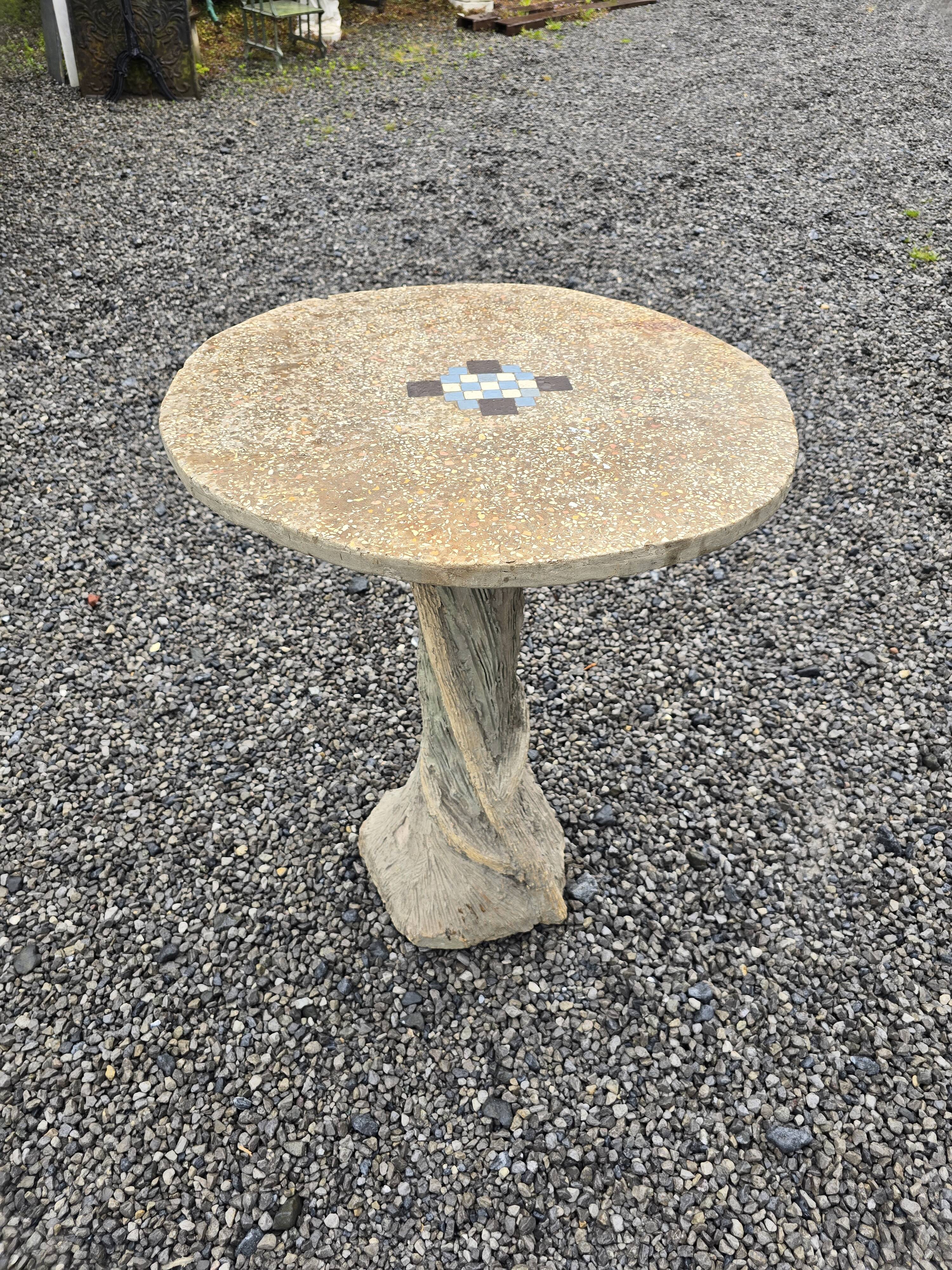 Cement garden table with trunk-shaped foot