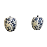 A pair of Chinese blue and white ovoid vases and flush-fitting circular covers