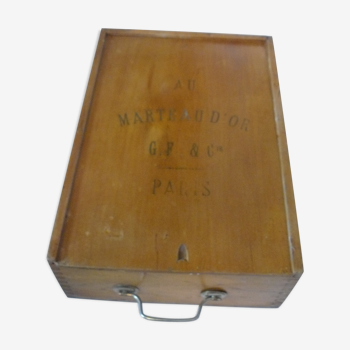 Wooden storage box marked "with a golden hammer"