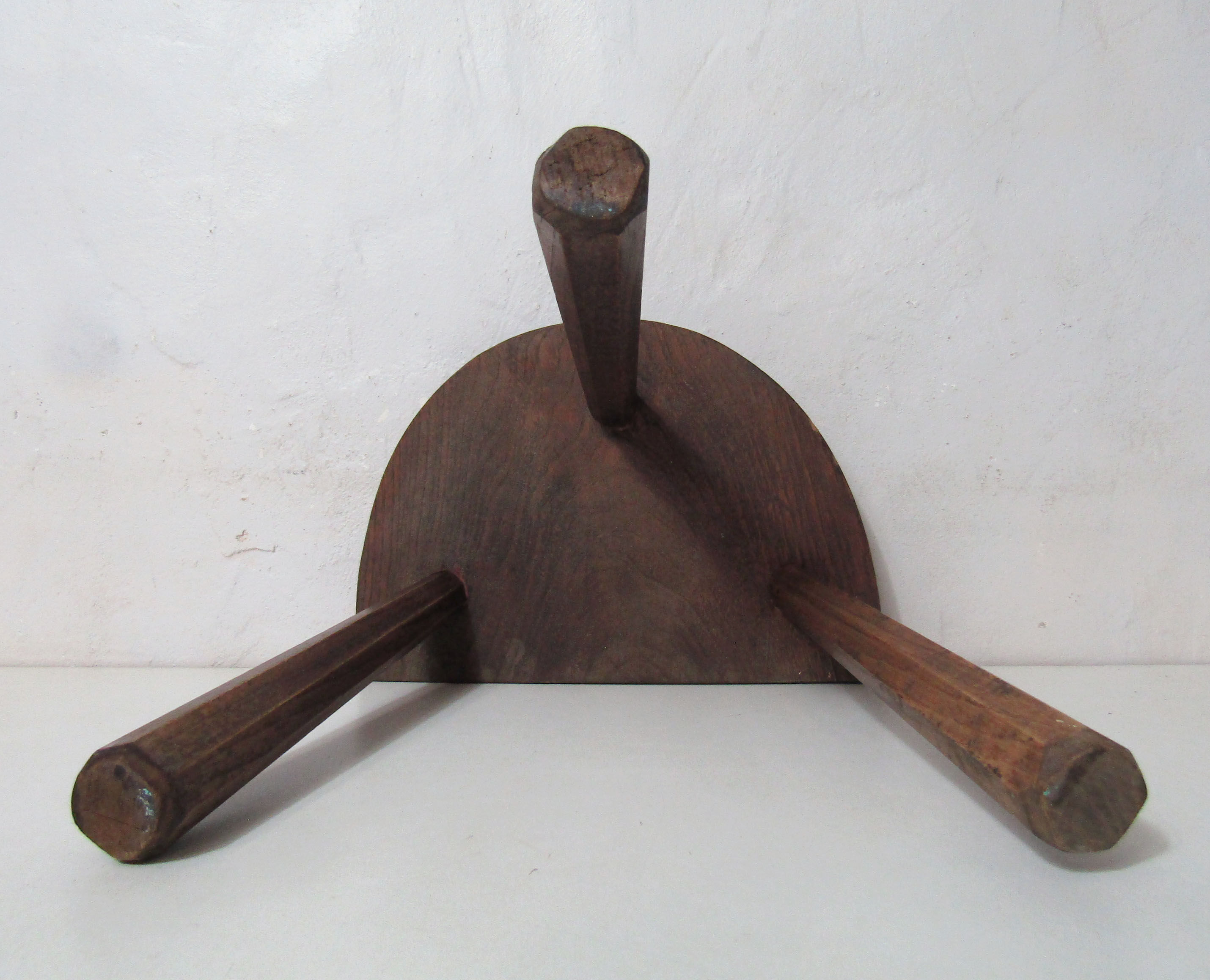 Old half-moon wooden tripod stool