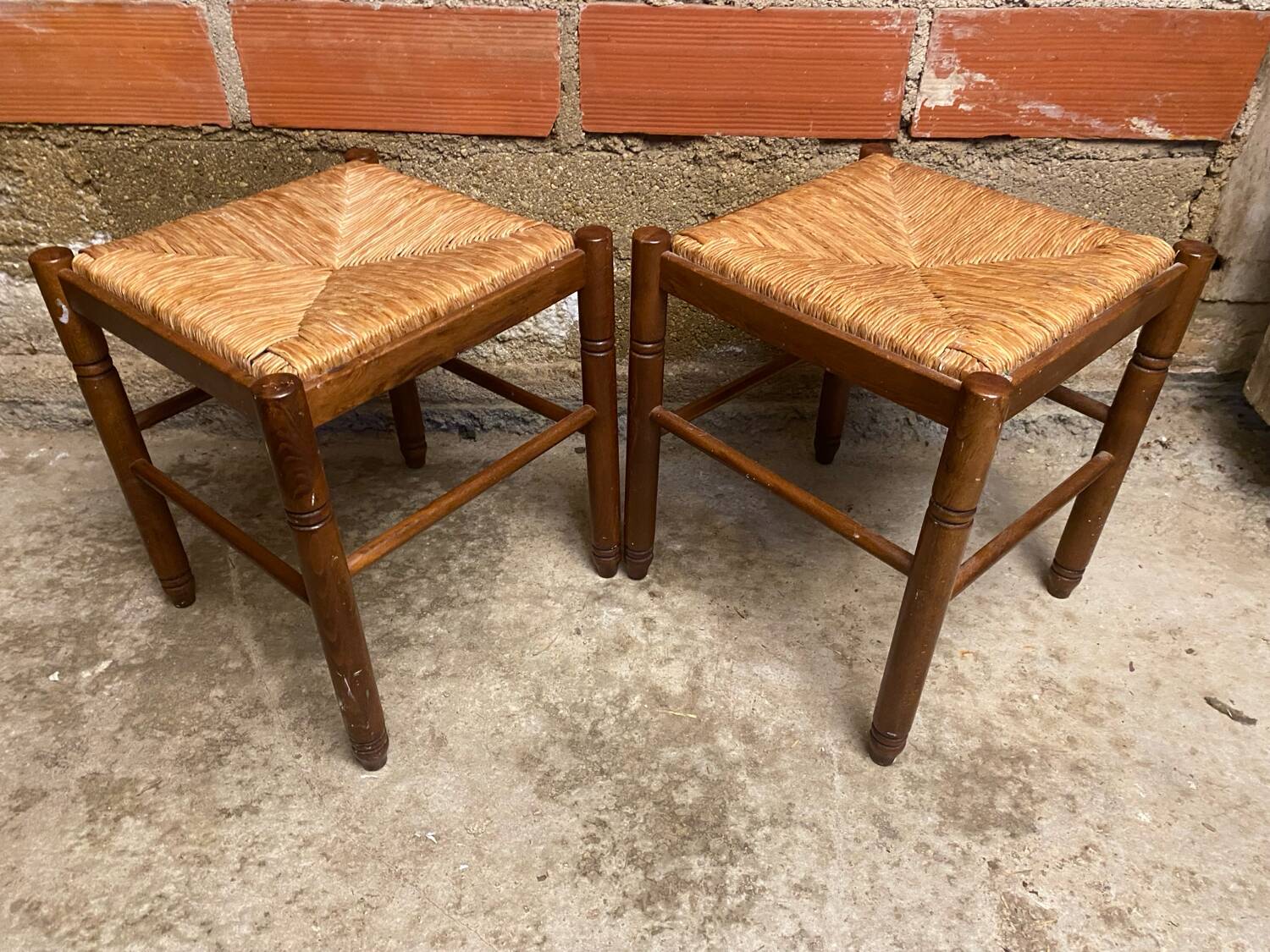 Pair of vintage wooden stools with woven straw seats