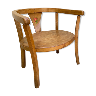 Old armchair for children in wood