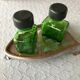 Salt/pepper green glass jars on metal base