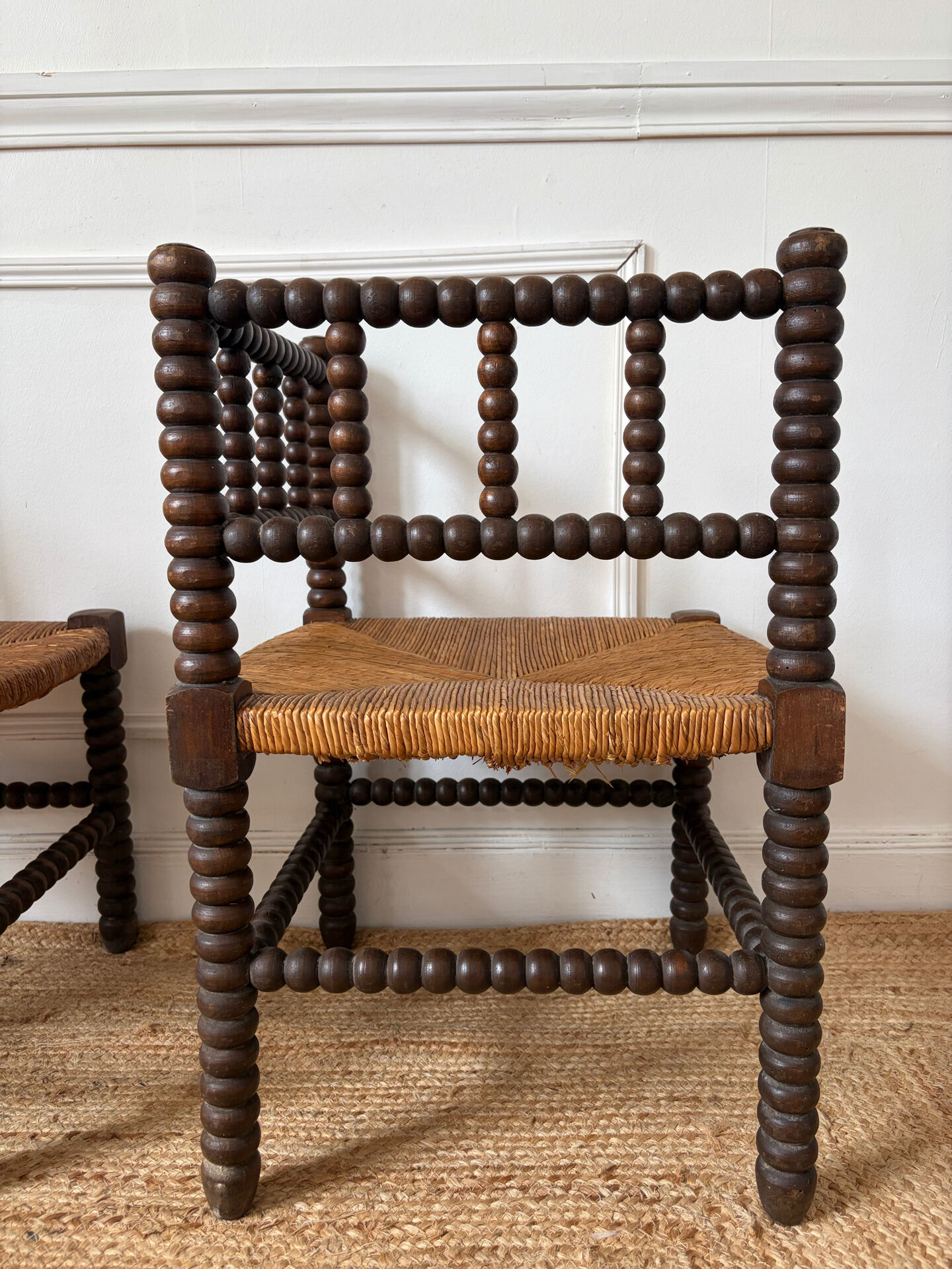 Pair of rush-seated chairs by the fireside "bobbin"