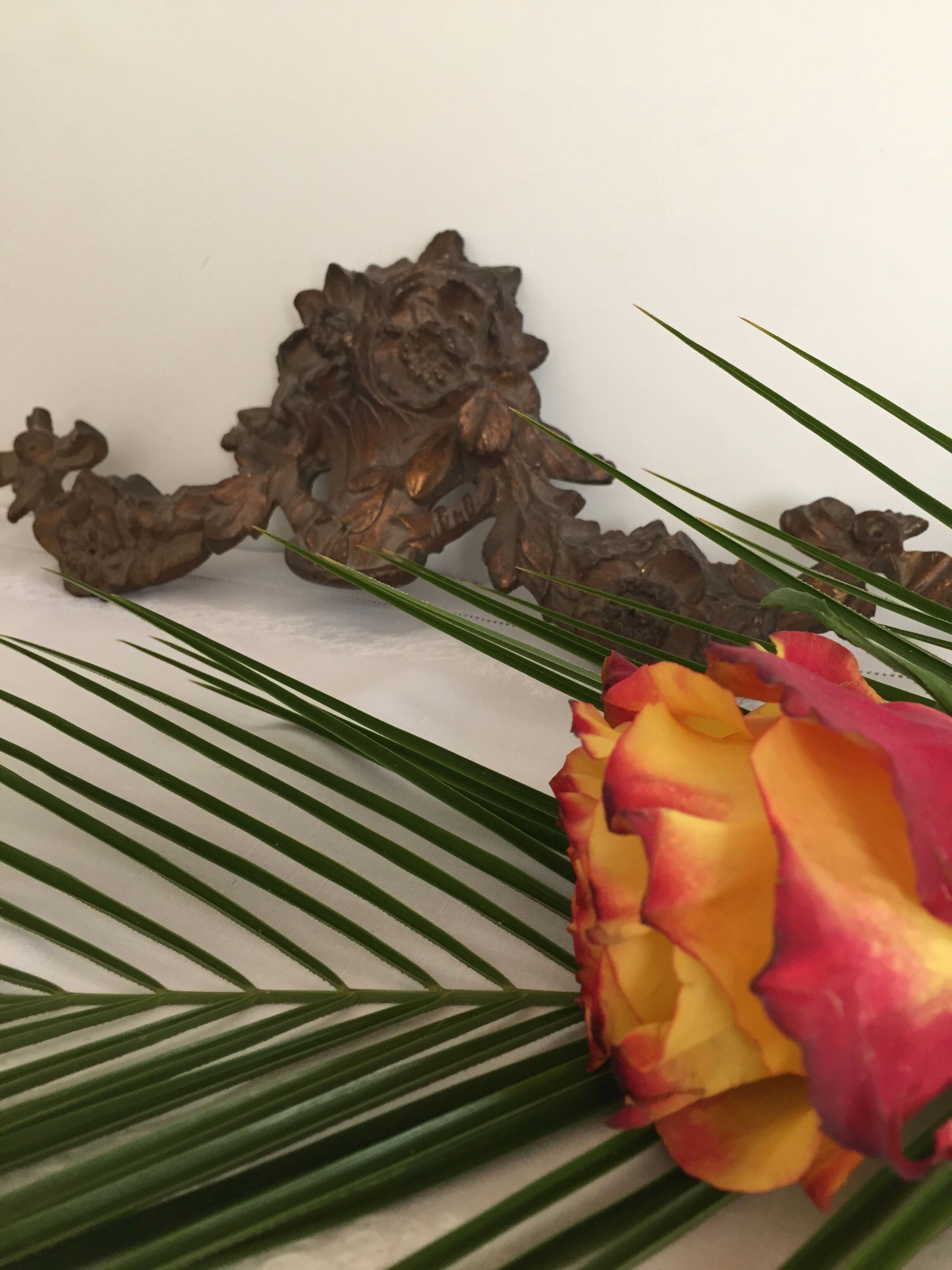 Old brass pediment, floral motifs and ribbon