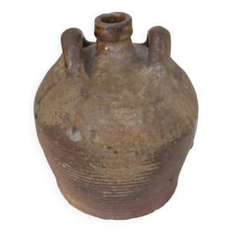 Old jug with 2 handles, in sandstone