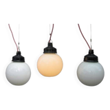 Trio of opal glass and bakelite globe pendant lights