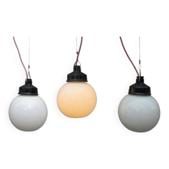 Trio of opaline glass and bakelite globe pendants