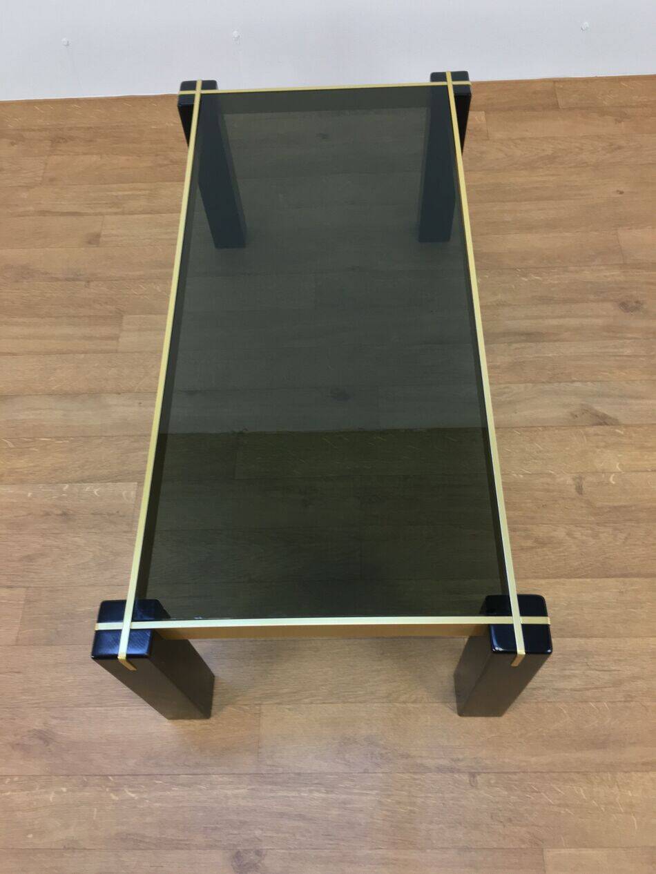 Italian coffee table from the 70s, smoked glass, black and gold lacquered wood.